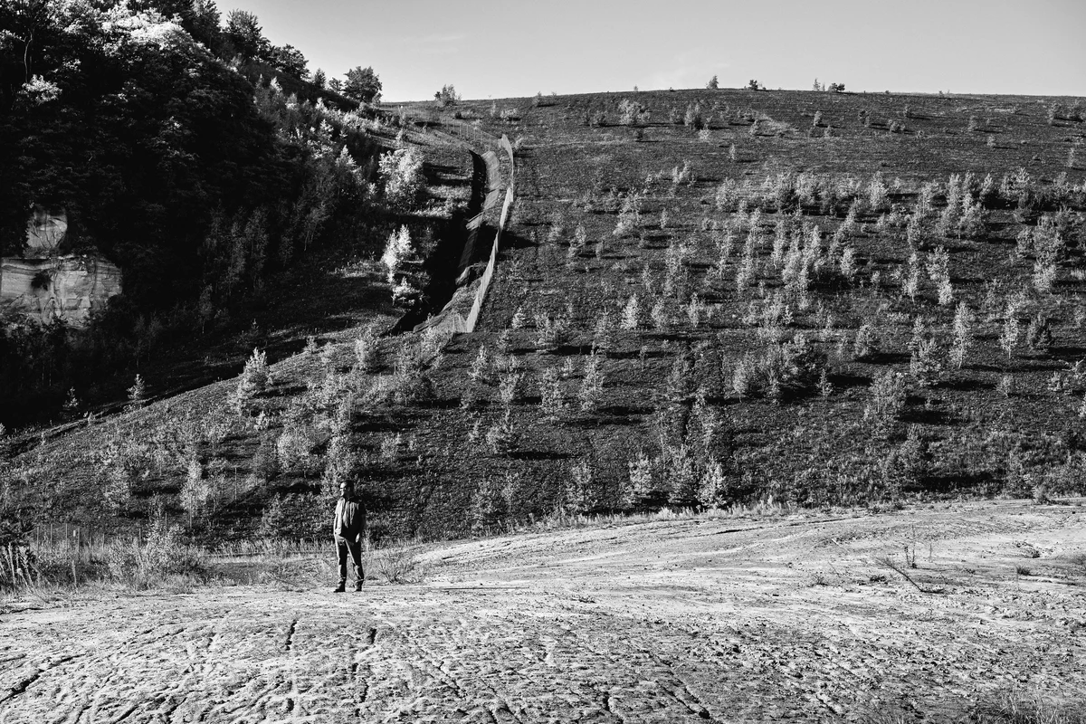 Jean-Baptiste Lusson, Président du GECNAL, au pied du terril. 2025. Carrière Barrois, Freyming-Merlebach. Ancien site industriel appartenant aux HBL (la compagnie d'extraction du charbon), le site est aujourd'hui une réserve de biodiversité et un lieu de balade.